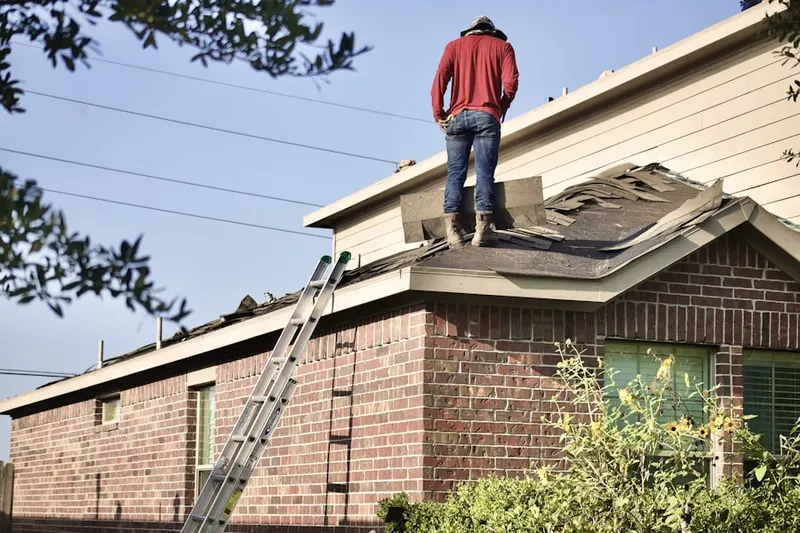 Professional roofer working on a residential roof in Atwood Acres